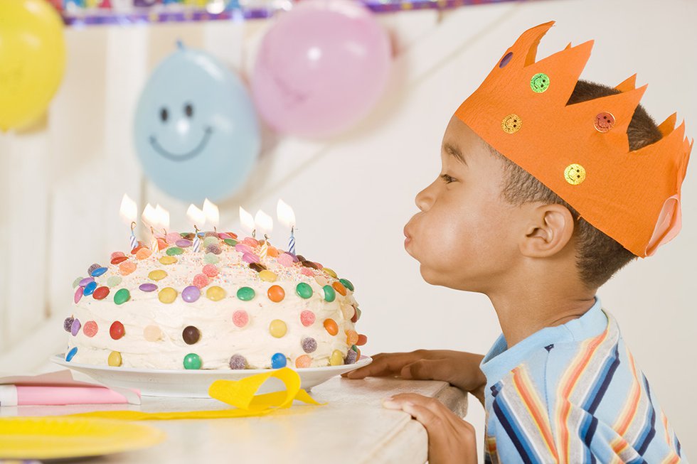 A girl blowing out candles on a cake